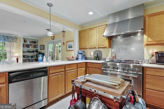 kitchen featuring appliances with stainless steel finishes, crown molding, plenty of natural light, and wall chimney exhaust hood