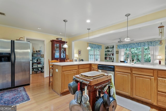 kitchen with ceiling fan, light hardwood / wood-style flooring, crown molding, decorative light fixtures, and appliances with stainless steel finishes