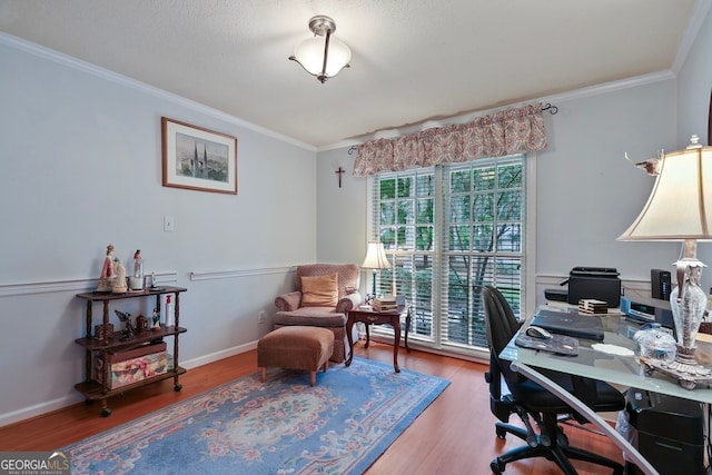 home office with hardwood / wood-style floors and ornamental molding