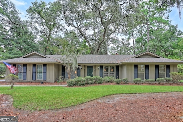 ranch-style home with a front lawn