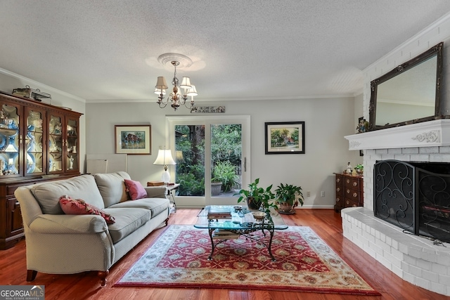 living room with wood-type flooring, a brick fireplace, and ornamental molding