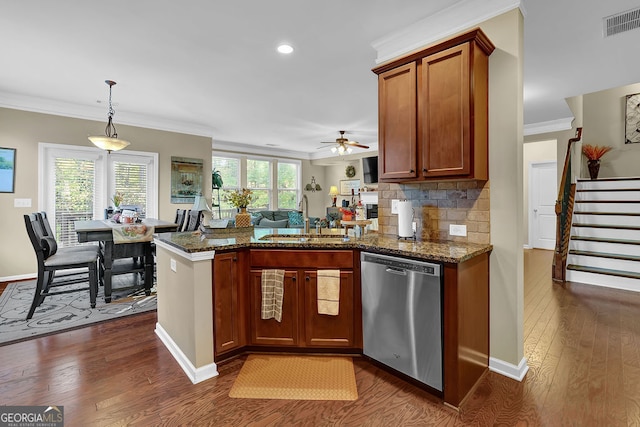 kitchen featuring dishwasher, sink, ceiling fan, decorative light fixtures, and dark hardwood / wood-style flooring