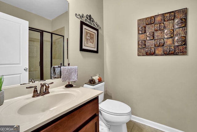 bathroom featuring toilet, vanity, tile patterned floors, and a shower with door