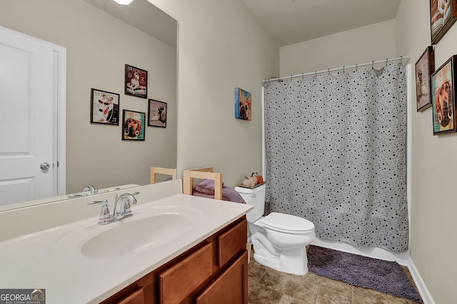 bathroom featuring vanity, toilet, and walk in shower