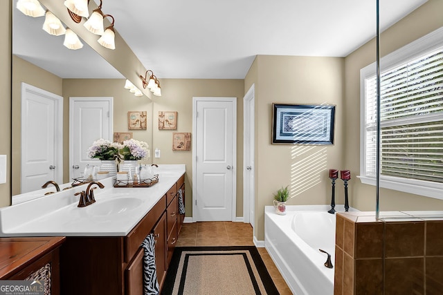 bathroom featuring tile patterned floors, vanity, and a washtub