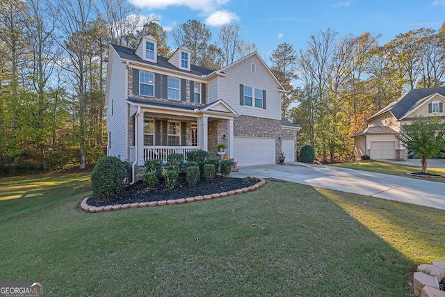 view of front of home featuring a front lawn, a porch, and a garage