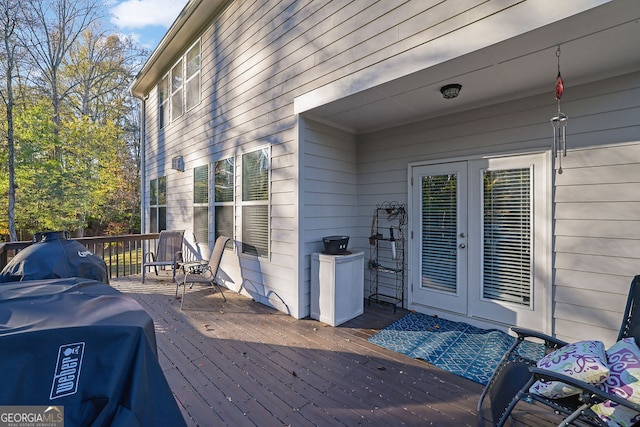 wooden deck featuring grilling area and french doors