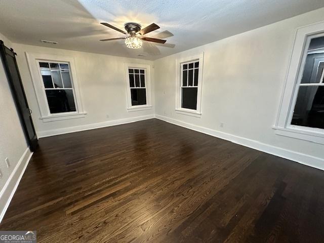 unfurnished room featuring ceiling fan and dark hardwood / wood-style flooring