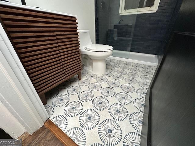 bathroom featuring a shower and toilet