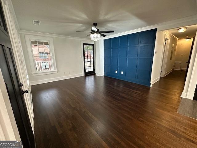 interior space with crown molding and dark hardwood / wood-style flooring