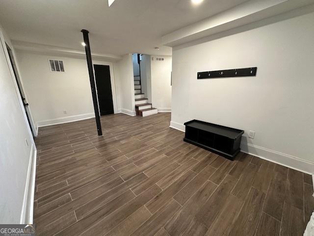 basement featuring dark hardwood / wood-style flooring