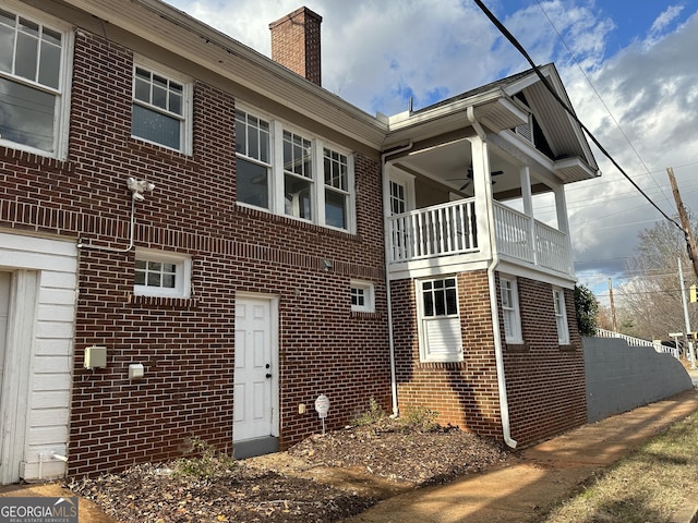 view of side of home featuring a balcony