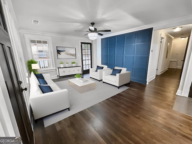 living room featuring crown molding, plenty of natural light, ceiling fan, and dark hardwood / wood-style flooring