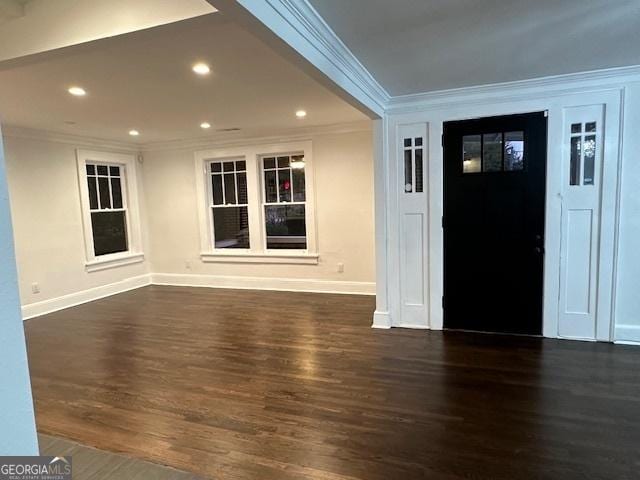 foyer with dark hardwood / wood-style flooring and ornamental molding