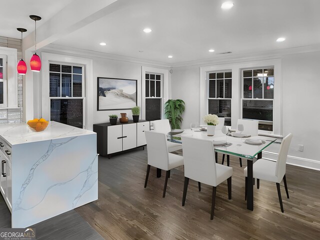 dining space featuring beam ceiling, ornamental molding, and dark hardwood / wood-style floors