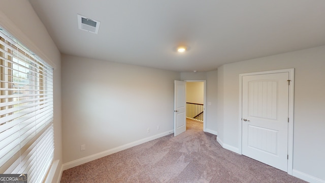 unfurnished bedroom featuring light colored carpet