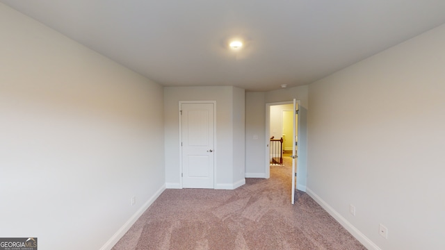 unfurnished bedroom featuring light carpet