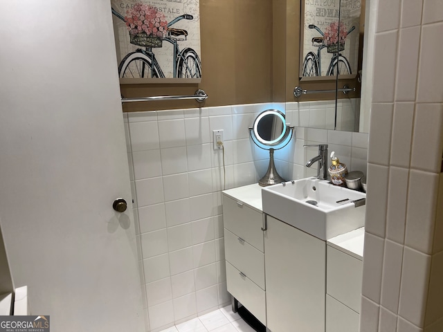 bathroom featuring tile patterned flooring, vanity, and tile walls