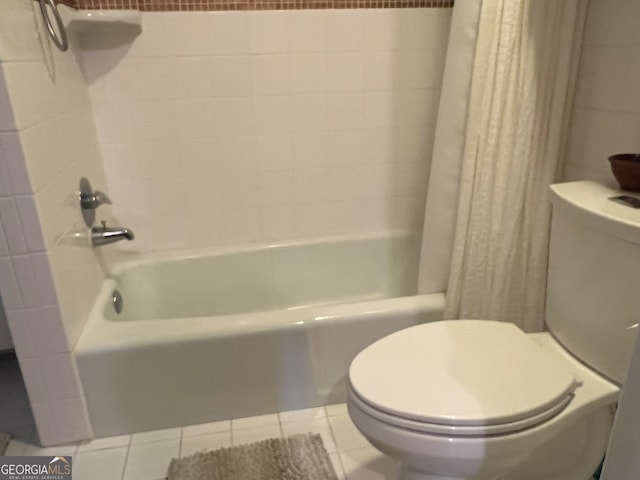 bathroom with tile patterned flooring, shower / bath combination with curtain, and toilet