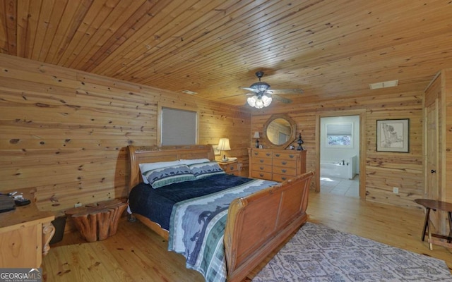 bedroom with wood walls, ceiling fan, light hardwood / wood-style floors, and wooden ceiling