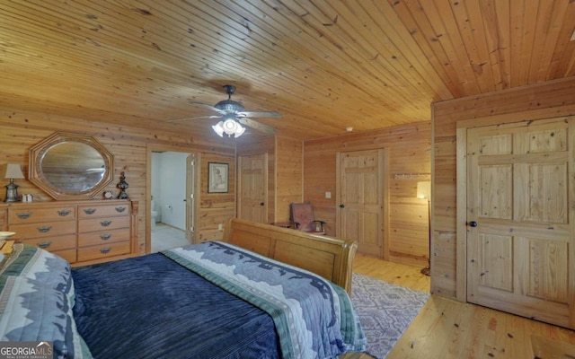 bedroom with ceiling fan, wood walls, light wood-type flooring, and wood ceiling