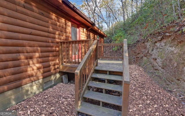 view of side of property featuring a wooden deck