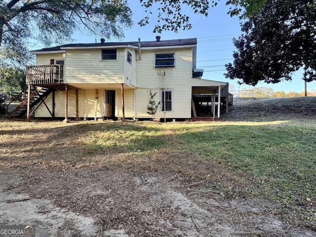 back of house featuring a yard and a wooden deck