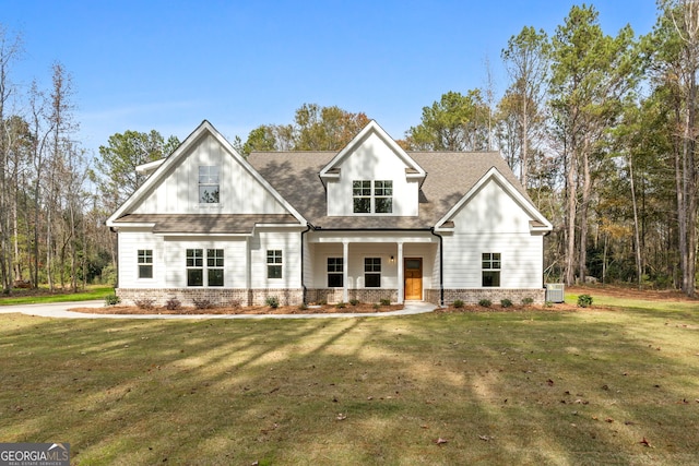 exterior space with a lawn, a porch, and central AC unit