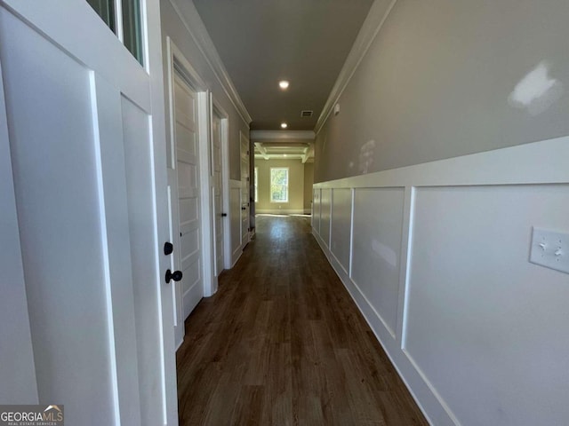 corridor with dark hardwood / wood-style floors and crown molding