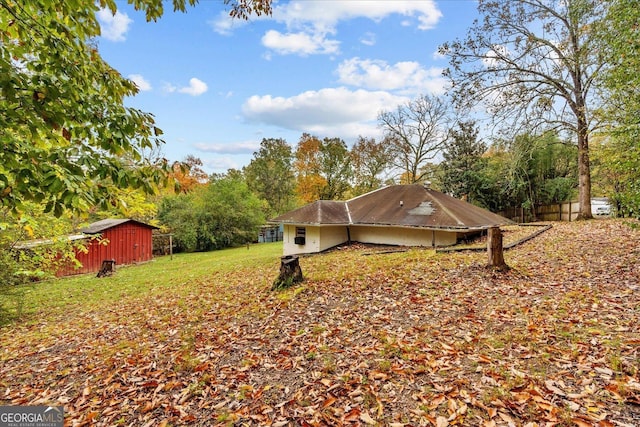 650 Mccharles St, Dalton, GA 30720 - view of side of property featuring a yard, a carport, and an outdoor structure