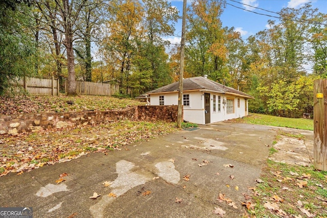 650 Mccharles St, Dalton, GA 30720 - view of side of property with fence, driveway, an outdoor structure, roof with shingles, and a patio area