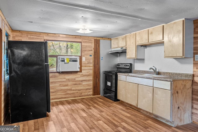 kitchen featuring sink, a wall mounted air conditioner, light hardwood / wood-style flooring, wood walls, and black appliances