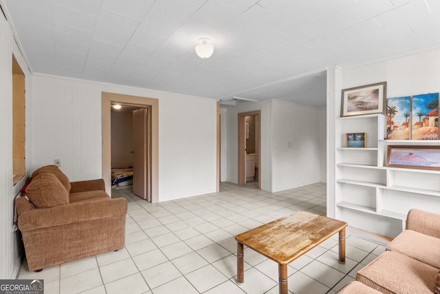 living room featuring wood walls and light tile patterned floors