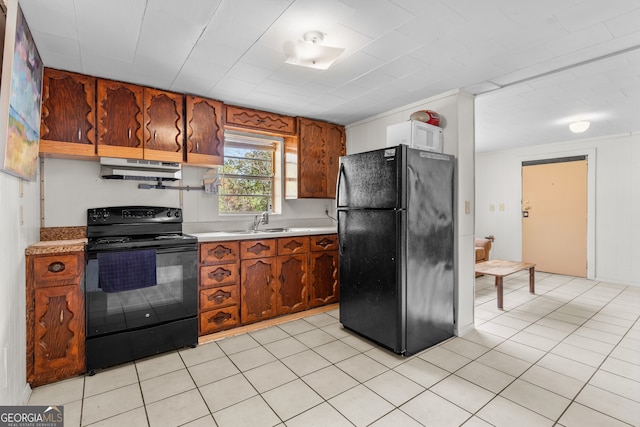 kitchen with sink, light tile patterned floors, and black appliances