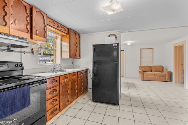 650 Mccharles St, Dalton, GA 30720 - kitchen featuring black appliances, a sink, light countertops, light tile patterned floors, and brown cabinetry