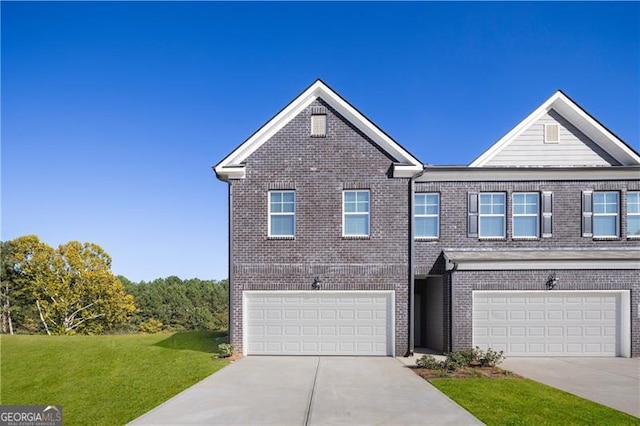 view of front of property featuring a front yard and a garage