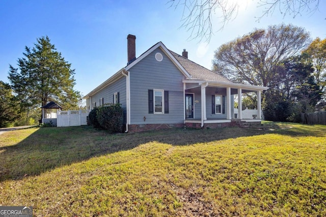 view of front of house with crawl space, fence, a chimney, and a front lawn