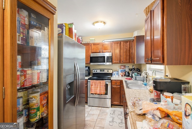 kitchen featuring light tile patterned floors, sink, and appliances with stainless steel finishes