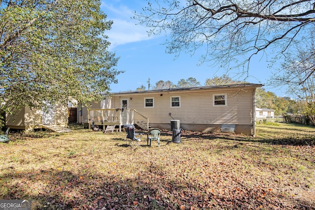 back of house with a yard and a wooden deck