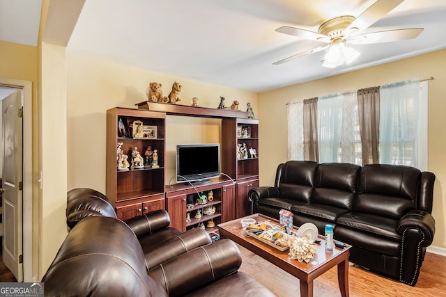 living room with ceiling fan and light hardwood / wood-style flooring