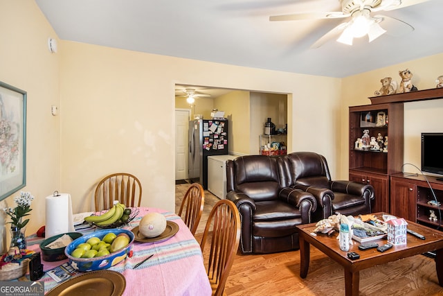 living room featuring light hardwood / wood-style flooring and ceiling fan