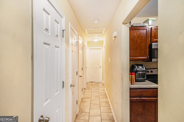 hallway with light tile patterned floors