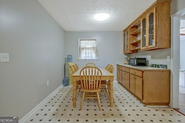 dining area featuring a textured ceiling