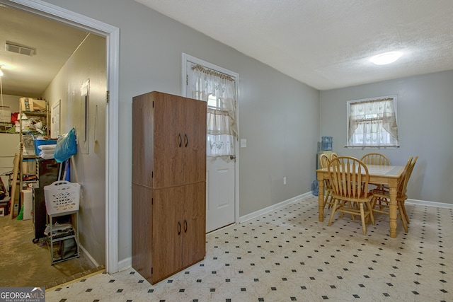 dining area with a textured ceiling