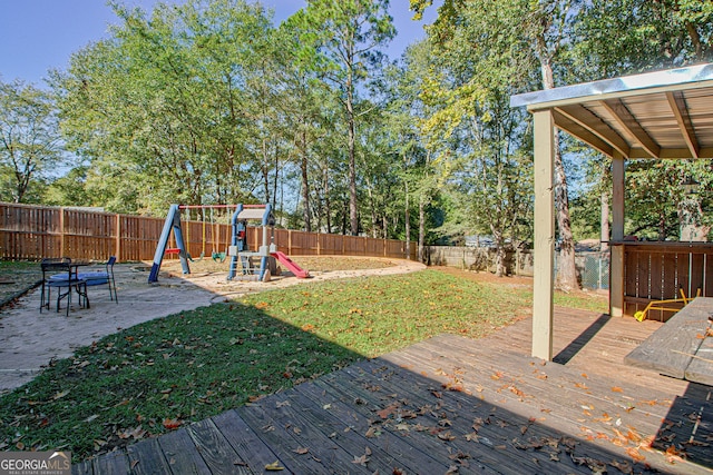 view of yard featuring a playground and a deck