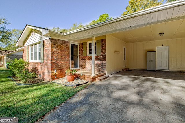 exterior space with a carport, covered porch, and a front lawn