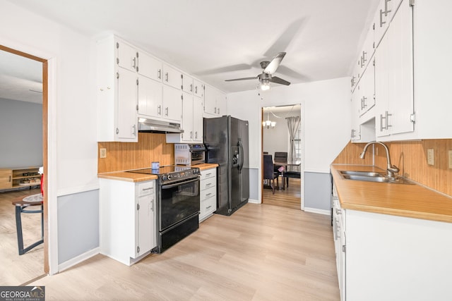 kitchen featuring ceiling fan with notable chandelier, sink, black appliances, white cabinets, and light hardwood / wood-style floors