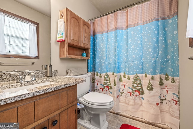 bathroom with vanity, toilet, and walk in shower