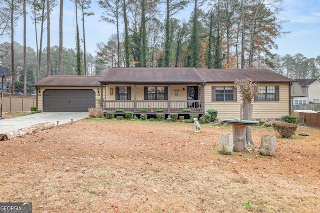 single story home with a porch and a garage