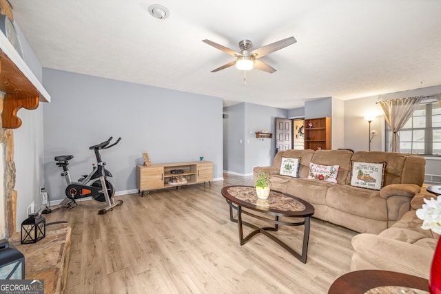 living room featuring light hardwood / wood-style floors and ceiling fan